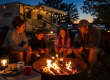 Family roasting marshmallows around a campfire during an evening at Elizabethtown / Hershey KOA Holiday