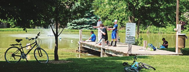 Family fishing together at Elizabethtown / Hershey KOA Holiday during a relaxing long weekend in Central Pennsylvania