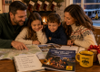 Family gathered around a table planning their next camping vacation at Elizabethtown / Hershey KOA Holiday