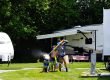 Family enjoying outdoor fun together at their RV campsite at Elizabethtown / Hershey KOA Holiday