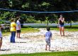 Families enjoying a game of sand volleyball at Elizabethtown / Hershey KOA Holiday during a camping vacation