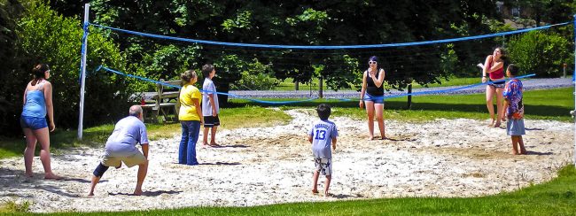 Rain or Shine Family Fun at Elizabethtown / Hershey KOA Holiday Families enjoying a game of sand volleyball at Elizabethtown / Hershey KOA Holiday during a camping vacation