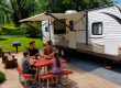 Family enjoying a relaxing meal together at their RV campsite at Elizabethtown / Hershey KOA Holiday
