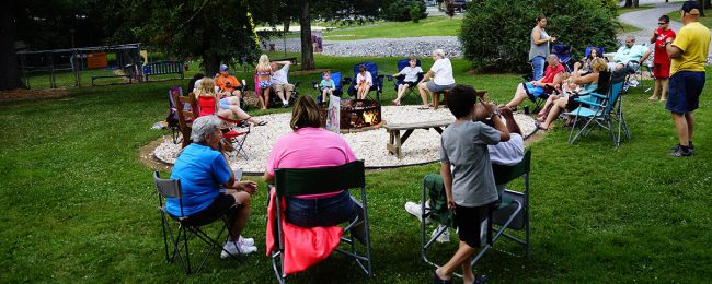 Why Families Return to Elizabethtown / Hershey KOA Year After Year Families gathering around a campfire at Elizabethtown / Hershey KOA Holiday